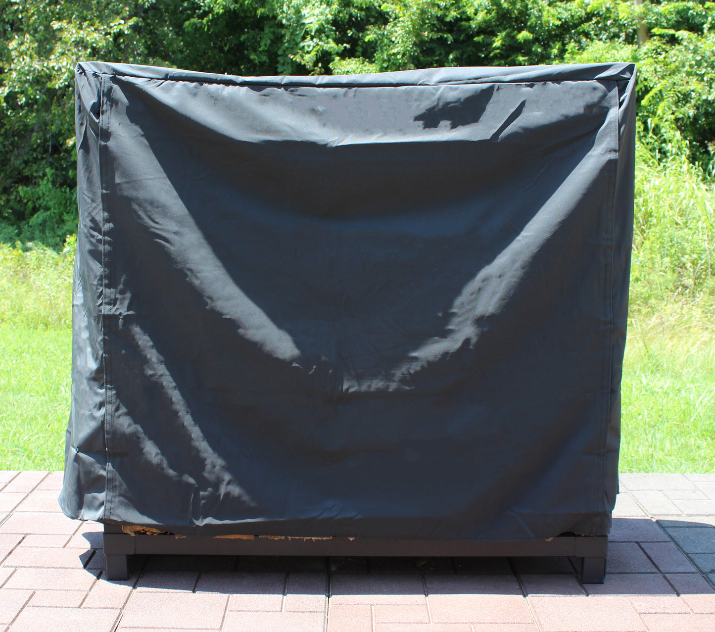4' Black Full Cover No Logo Lightweight   Firewood is covered on a patio.